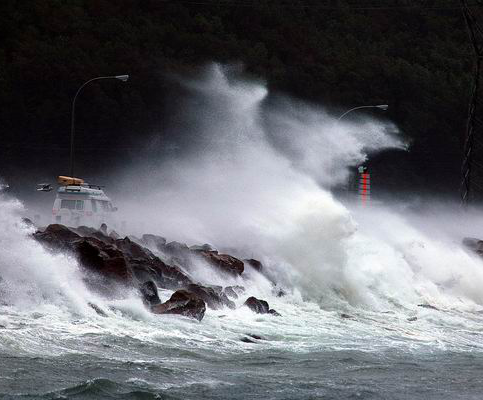 Huge wave washes over causeway